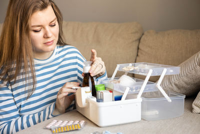 Portrait of young woman using mobile phone at home