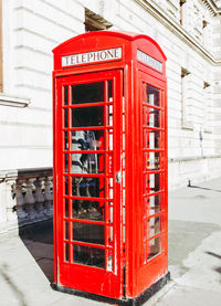 Red telephone booth on street