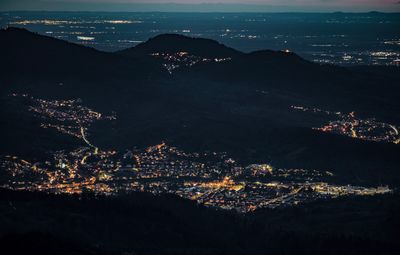 Aerial view of illuminated buildings in city at night