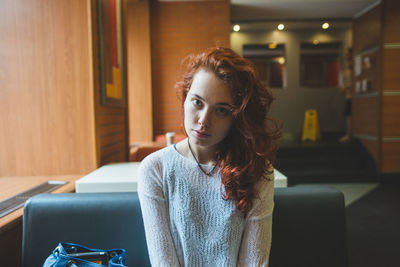 Portrait of young woman sitting at home