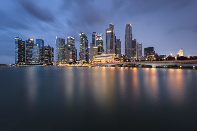 Lake against sky in city at night