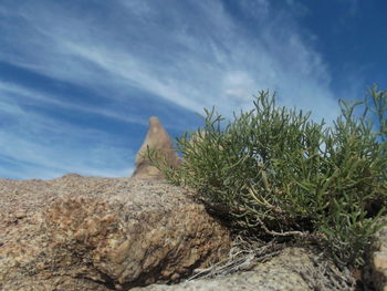 Low angle view of mountain against cloudy sky