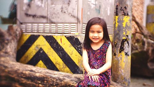 Portrait of smiling girl standing outdoors