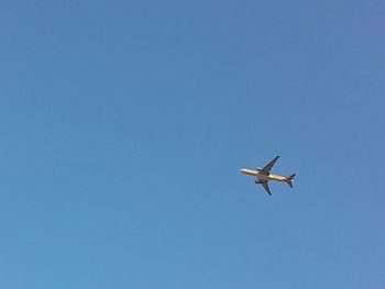 Low angle view of airplane flying in sky