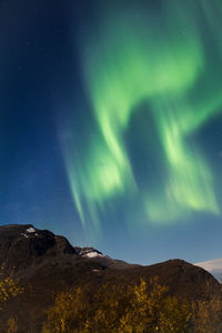 Low angle view of mountain against sky at night