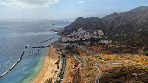 High angle view of sea and cityscape against sky