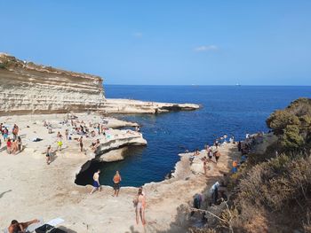 People on beach against sky