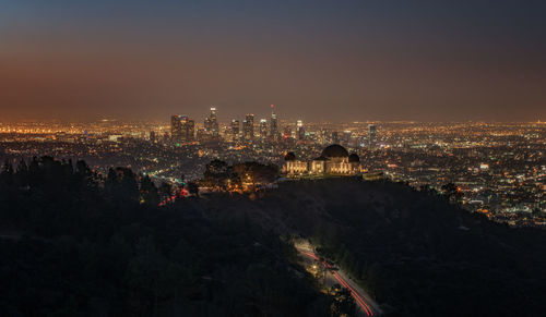 High angle view of city lit up at night