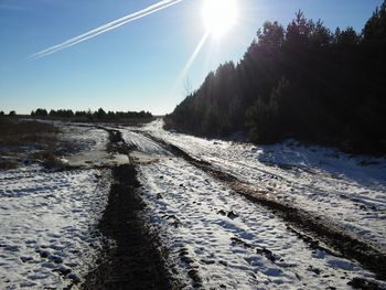 Snow covered landscape against sky