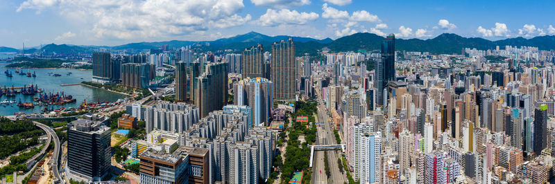 Aerial view of modern buildings in city against sky