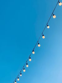 String wired bulbs on evening blue sky