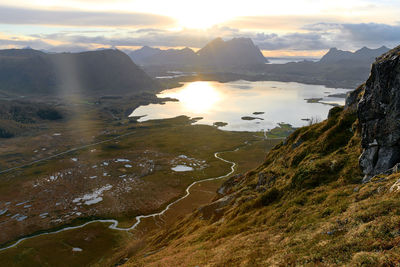 Scenic aerial view of landscape and sea against sky during sunset on lofoten islands in norway