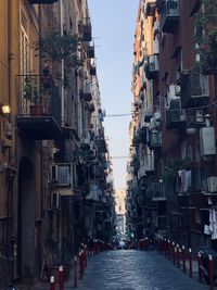 Street amidst buildings against sky in city