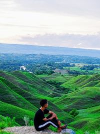 High angle view of man looking at landscape