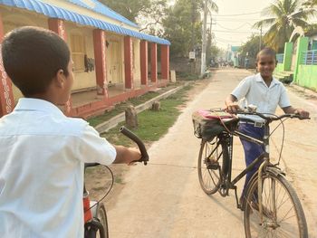 Side view of man riding bicycle on street