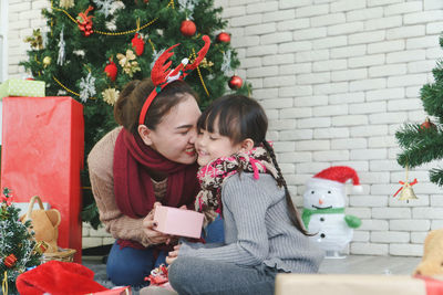 Women holding christmas tree