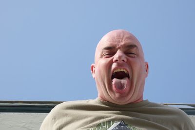 Portrait of man wearing sunglasses against clear sky