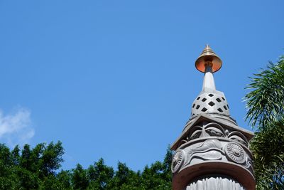 Low angle view of cross and trees against sky