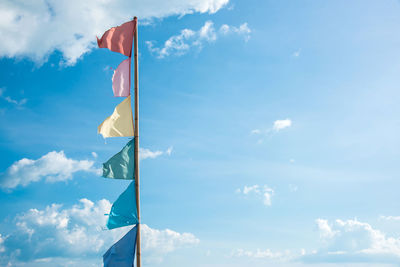 Low angle view of flag flags against sky