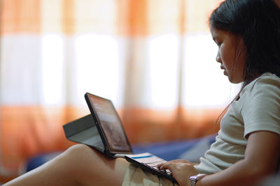 A girl using laptop at home