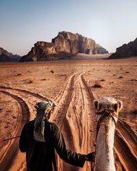 Man in desert against clear sky