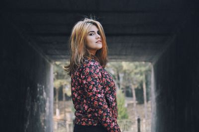 Young woman standing in tunnel