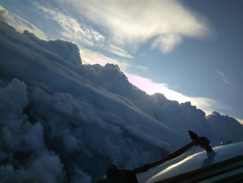 Low angle view of snowcapped mountains against sky