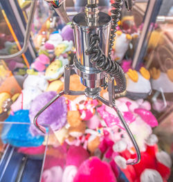 Close-up of machinery over toys in store for sale