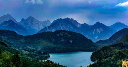 Scenic view of lake and mountains against sky