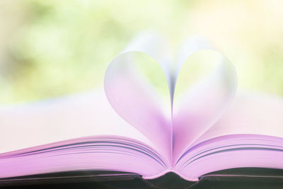 Close-up of heart shape on book at table