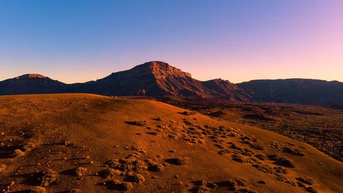 Scenic view of desert against sky during sunset