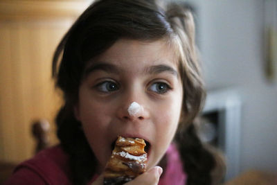 Close-up of girl eating dessert at home