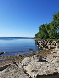 Scenic view of sea against clear blue sky