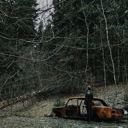 Man cycling on tree in forest
