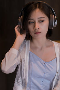 Beautiful woman listening music while sitting at home