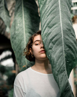 Portrait of woman by plants