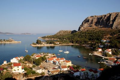 Scenic view of sea and buildings against clear sky