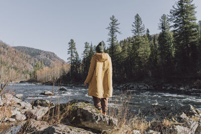 Woman looking at river on sunny day