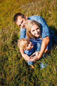 Full length of father and daughter on grass