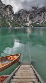 Scenic view of lake by mountains against sky