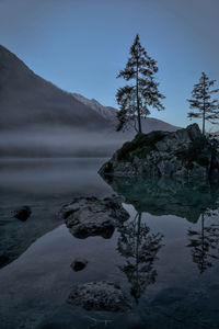 Scenic view of lake by mountain against sky