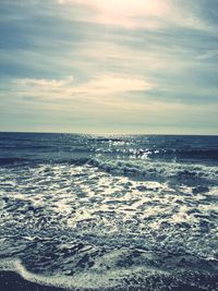 Scenic view of sea against cloudy sky