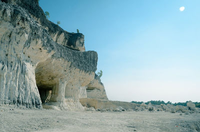 Rock formations on landscape against sky