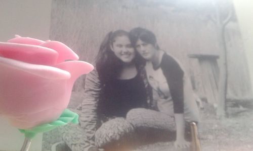 Close-up portrait of young woman holding hands at home