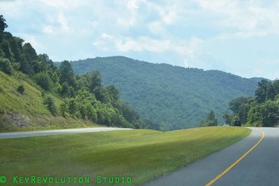 Scenic view of green landscape against sky