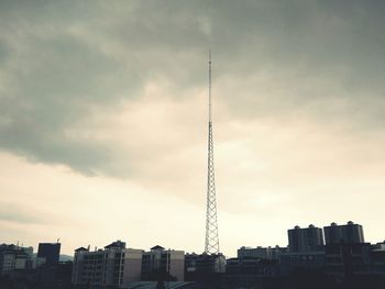 View of cityscape against cloudy sky