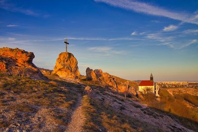 Rock formations on landscape against sky during sunset