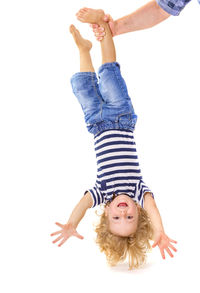 Low angle view of mother and daughter against white background