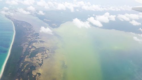 Aerial view of sea and mountains against sky