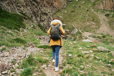 Rear view of woman standing amidst plants